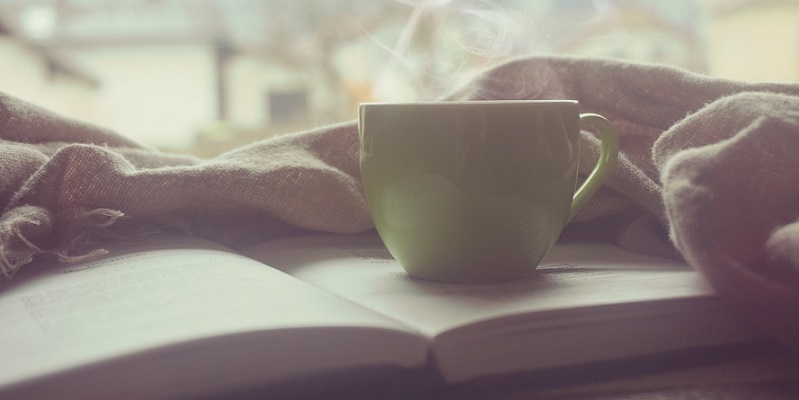 A steamy cup of tea on an open book: vein treatment options.