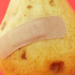 bruised fruit with band aid signifying leg wounds or ulcers