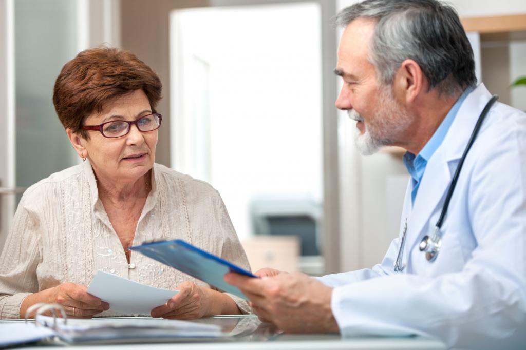 older woman talking with her doctor, image is being used to represent why it is important to get treatment for varicose veins