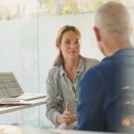doctor talking to male patient about his vein treatment options