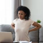 woman sitting too long realizing it is unhealthy