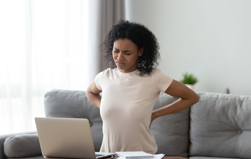 woman sitting too long realizing it is unhealthy