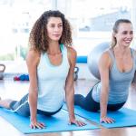 two middle-aged women doing yoga to improve circulation