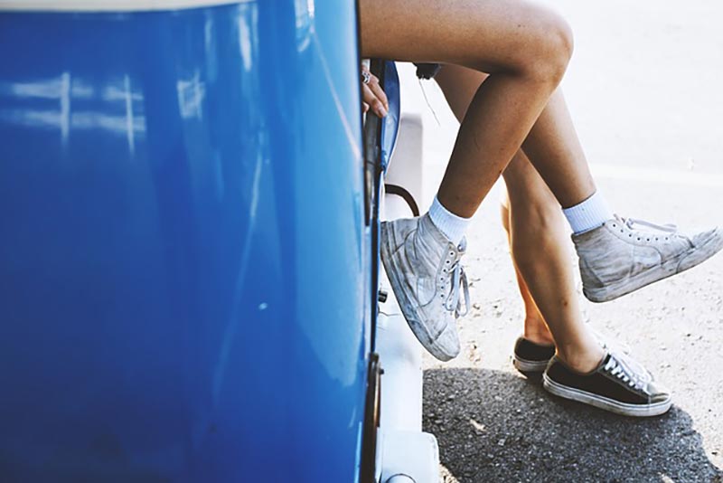 legs leaning on car