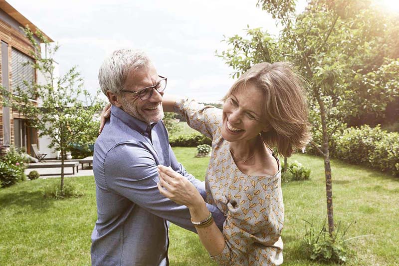 couple dancing outside in the grass