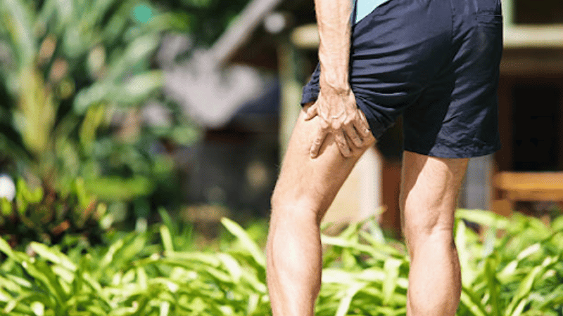 Why It Can Be Painful To Stand If You Have Varicose Veins 6 Woman standing at work experiencing leg pain from varicose veins