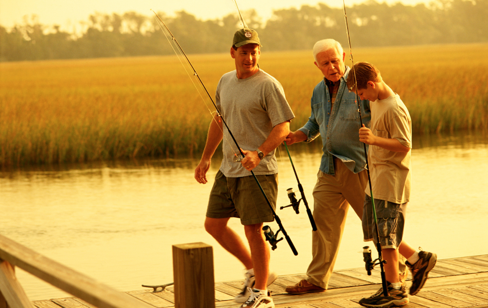 granfather, father, and son fishing on dock