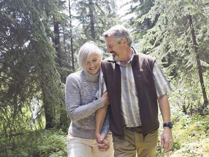 old couple laughing in forest