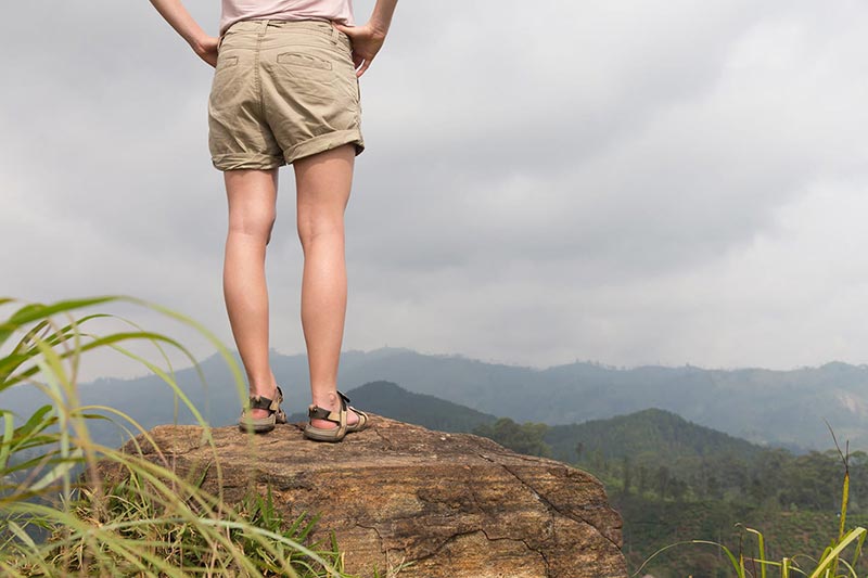 woman standing on top of mountain