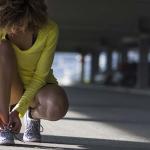woman tying her shoes before a run