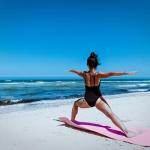 Woman doing yoga pose on the beach