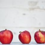 row of red apples lined up
