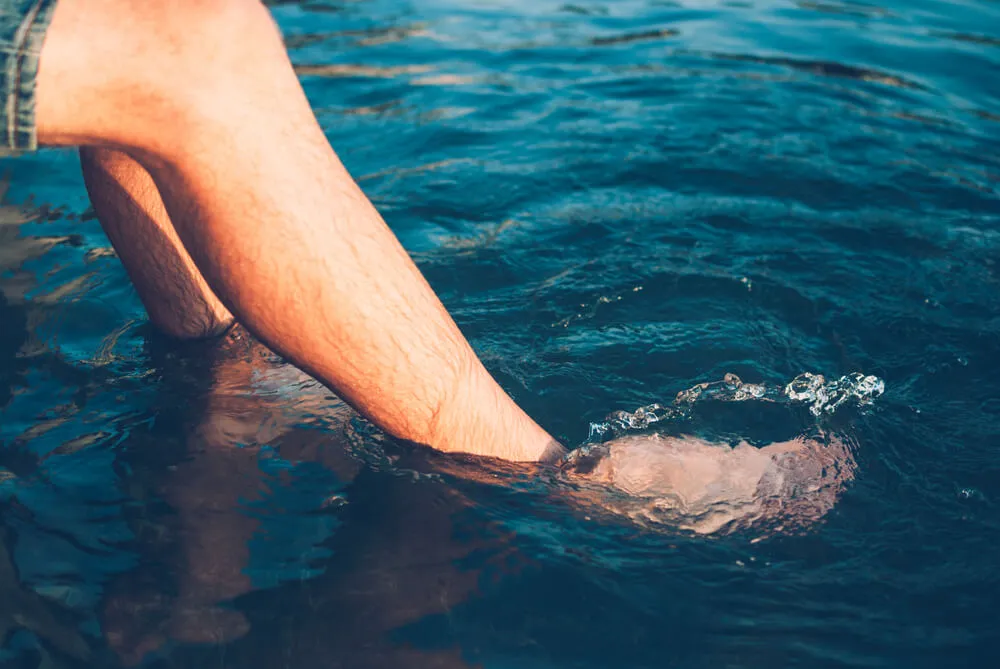 Man Dipping His Feet into Hot Tub