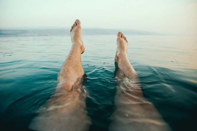 person with legs floating in water