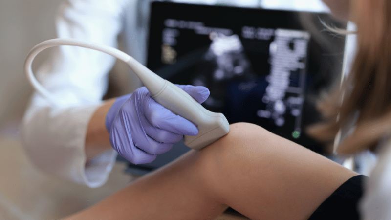 Duplex Ultrasound Being Performed On Leg Veins By Vein Specialist Ultrasound examination of a patient's leg