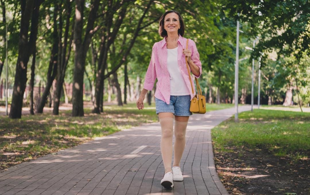 Varicose Vein Treatment Recovery 5 Woman walks through a park while wearing compression socks.