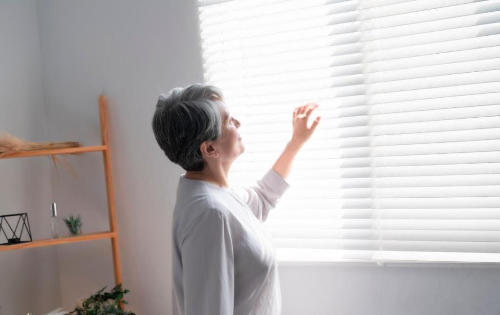 Can You Die From Chronic Venous Insufficiency? 5 A woman looking out through the window blinds