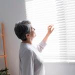 Can You Die From Chronic Venous Insufficiency? 6 A woman looking out through the window blinds
